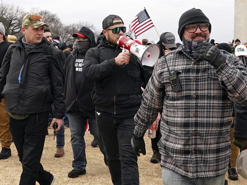 caption: Proud Boys members including Zachary Rehl, left, Ethan Nordean, center, and Joseph Biggs, walk toward the U.S. Capitol in Washington, in support of President Donald Trump on Jan. 6, 2021.