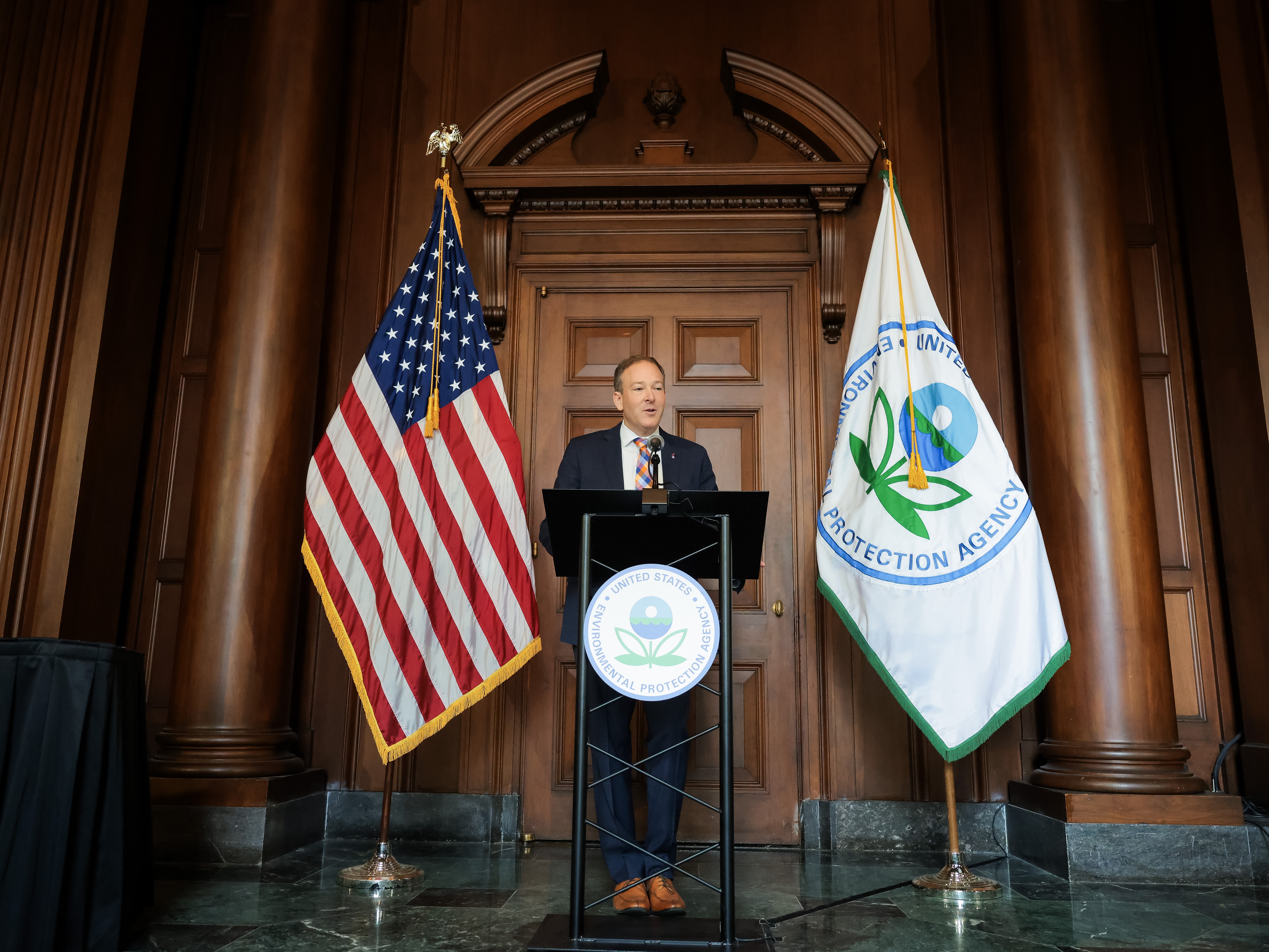 caption: Environmental Protection Agency Administrator Lee Zeldin speaking at EPA headquarters in 2025.