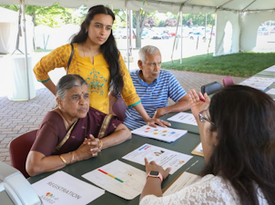caption: Attendees at a health fair at the  Balaji Temple, in Aurora, Ill., learn about the SAHELI diabetes prevention program.
