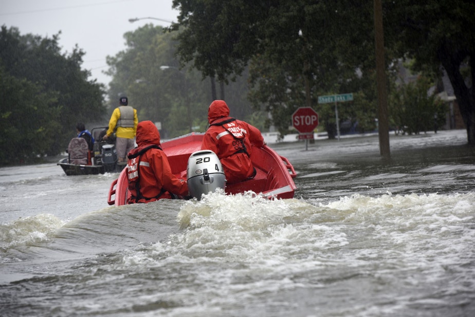 caption: Coast Guard Petty Officers 3rd Class Eric Gordon and Gavin Kershaw pilot a 16-foot flood punt boat and join good Samaritans in patrolling a flooded neighborhood in Friendswood, Texas, Aug. 29, 2017. The flood punt team from Marine Safety Unit Paducah, Ken