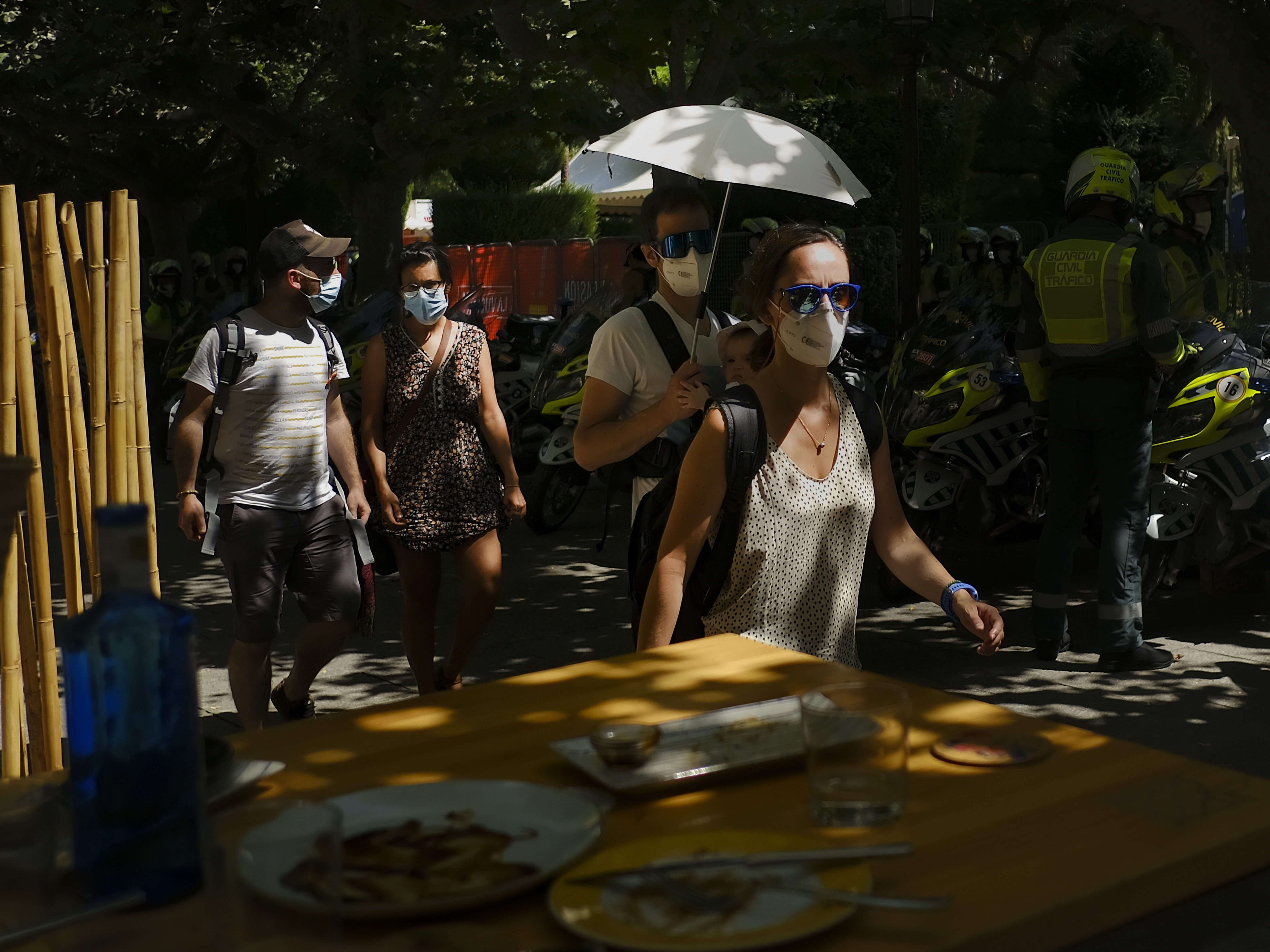 caption: A man shelters a baby from the sun with an umbrella during a heatwave in Burgos, northern Spain, Saturday, Aug. 14, 2021. Cities in Europe saw recording-setting heat this summer, with some regions reaching 117.3°F.