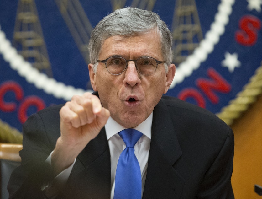 caption: FCC Chairman Tom Wheeler gestures near the end of a hearing for a vote on Net Neutrality, Feb. 26, 2015