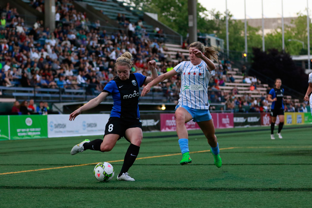 caption: Kim Little (left) of Seattle Reign FC plays at Memorial Stadium in Seattle during an 2015 NWSL match/