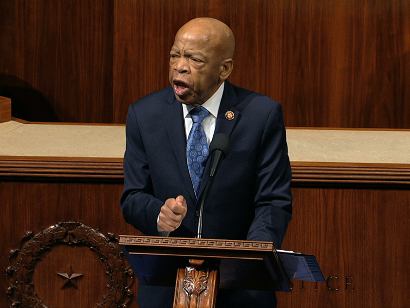 caption: Rep. John Lewis, D-Ga., speaks as the House of Representatives debates the articles of impeachment against President Trump this month. Lewis says he'll stay in office while he undergoes treatment for pancreatic cancer.