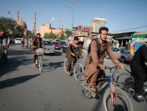 caption: Bicycles have become the only commuting option for many Afghans, who are often unable to afford a ride in a bus or a shared cab as the economy has unraveled under Taliban rule. But the conservative Taliban culture means that women are missing from the ranks of these new riders.