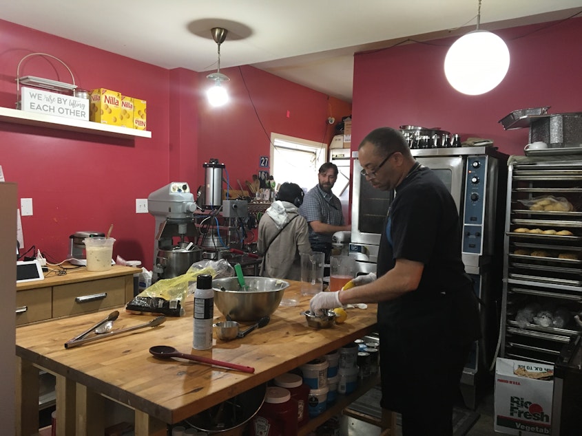 caption: Kelly Robersone of Simply Soulful in Madison Valley makes fresh lemonade as food inspector Mike Simpson inspects the restaurant's food safety handling practices.