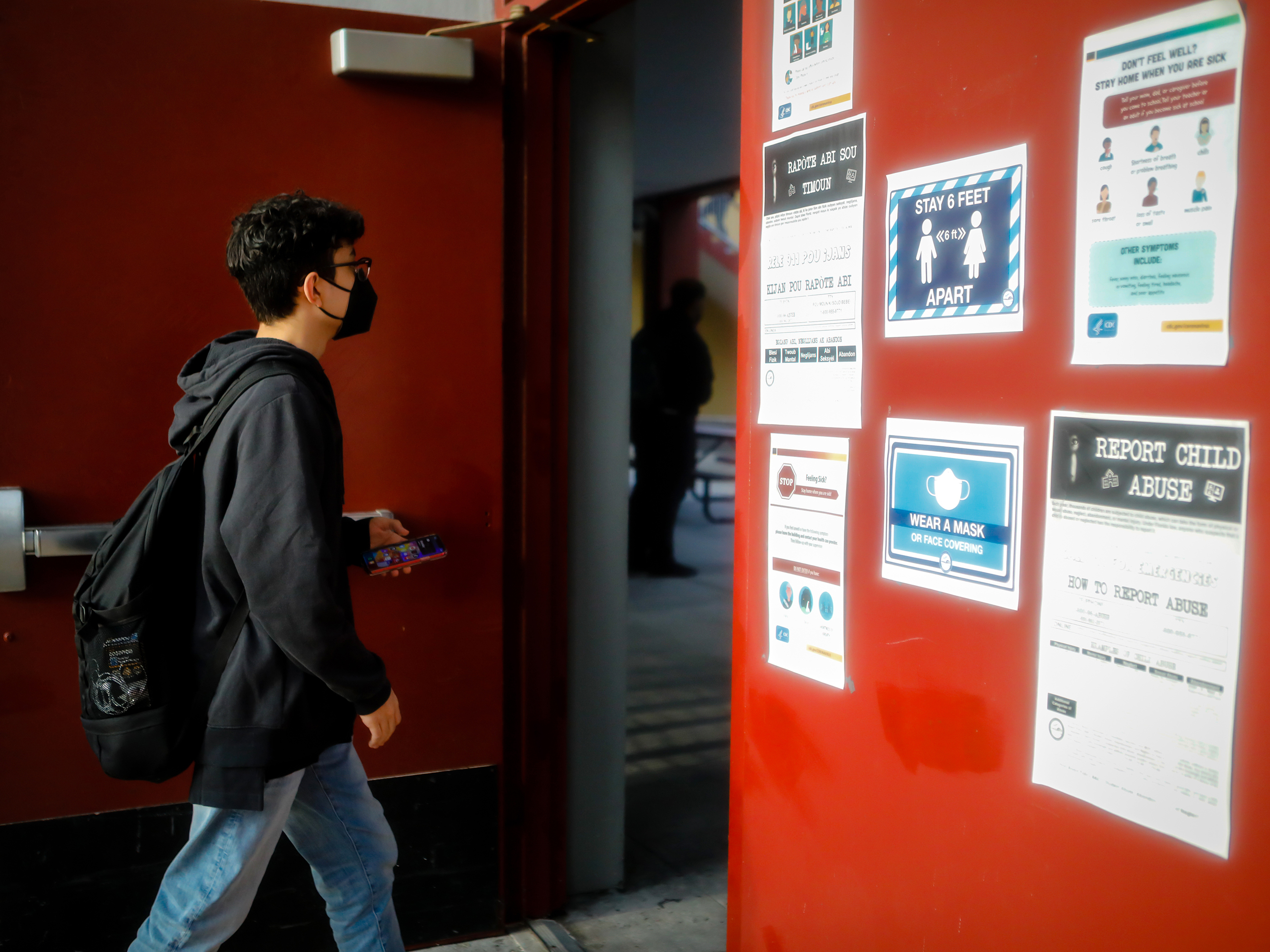 caption: A student arrives for the first day of classes at a public school in Miami Lakes, Fla., on Aug. 23.