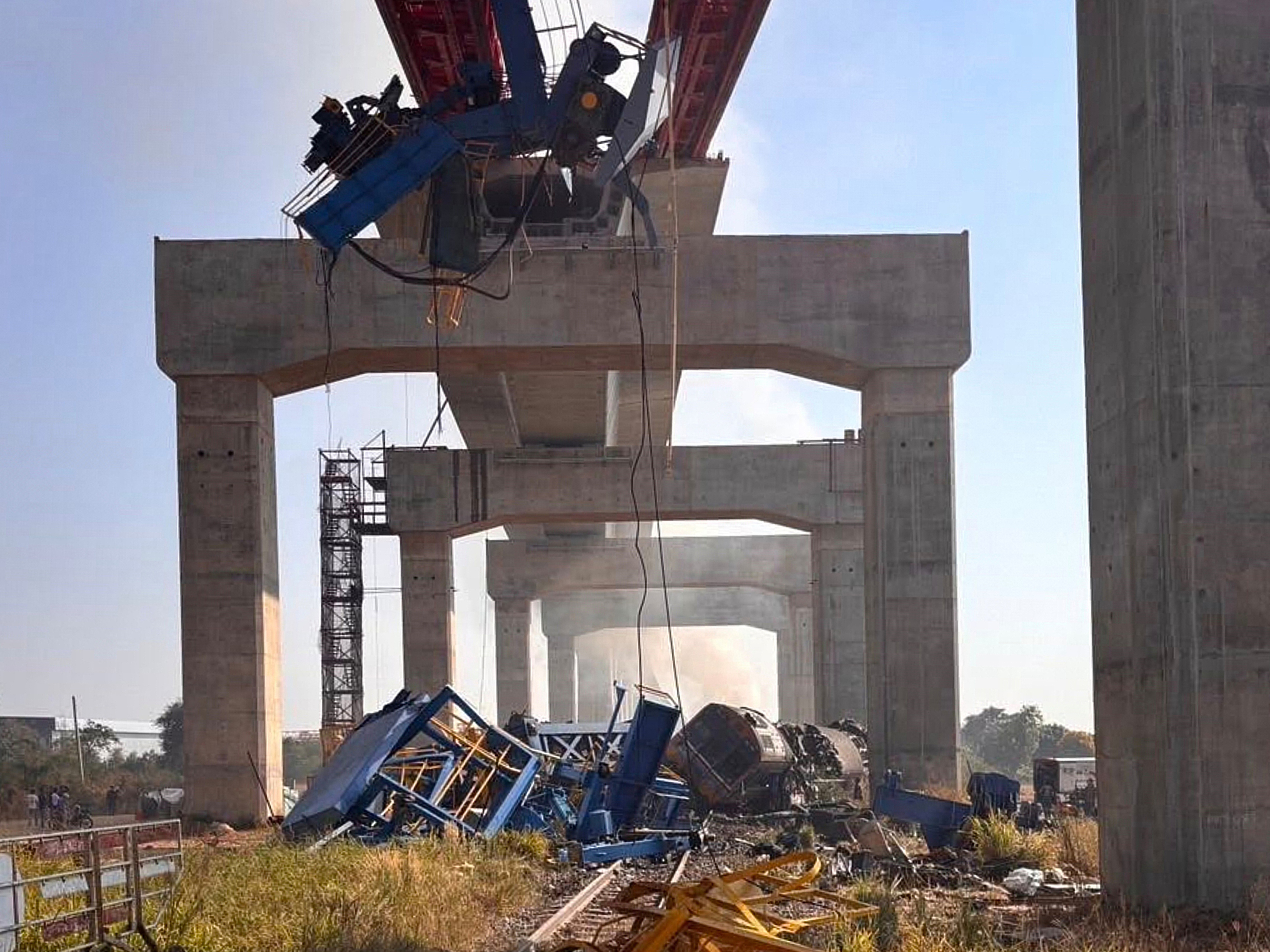 caption: This photo released from State Railway of Thailand, shows a scene after a construction crane fell into a passenger train in Nakhon Ratchasima province, Thailand on Wednesday.