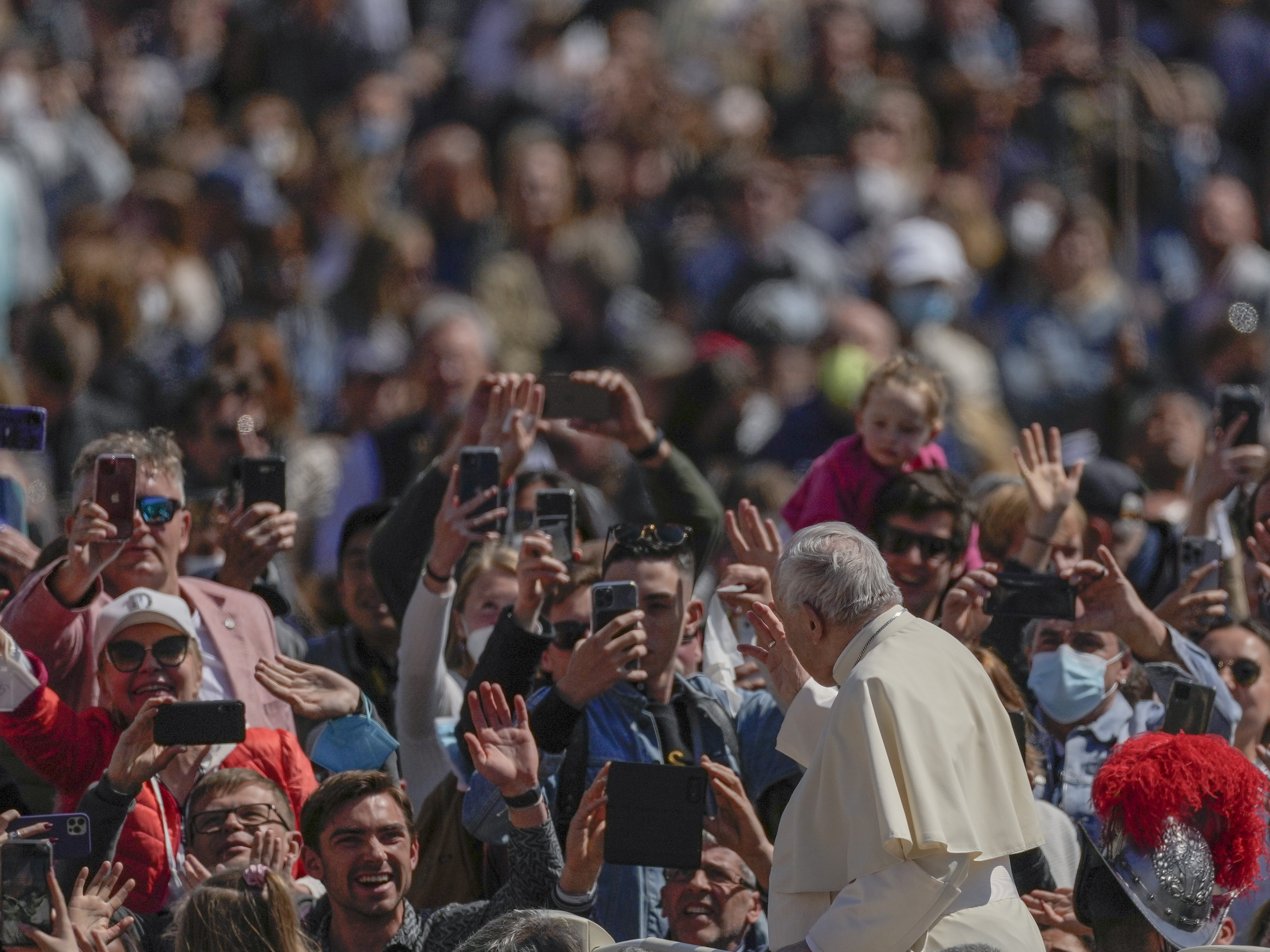 caption: Pope Francis on his popemobile drives through the crowd of faithful at the end of the Catholic Easter Sunday mass he led in St. Peter's Square at the Vatican, Sunday, April 17, 2022.