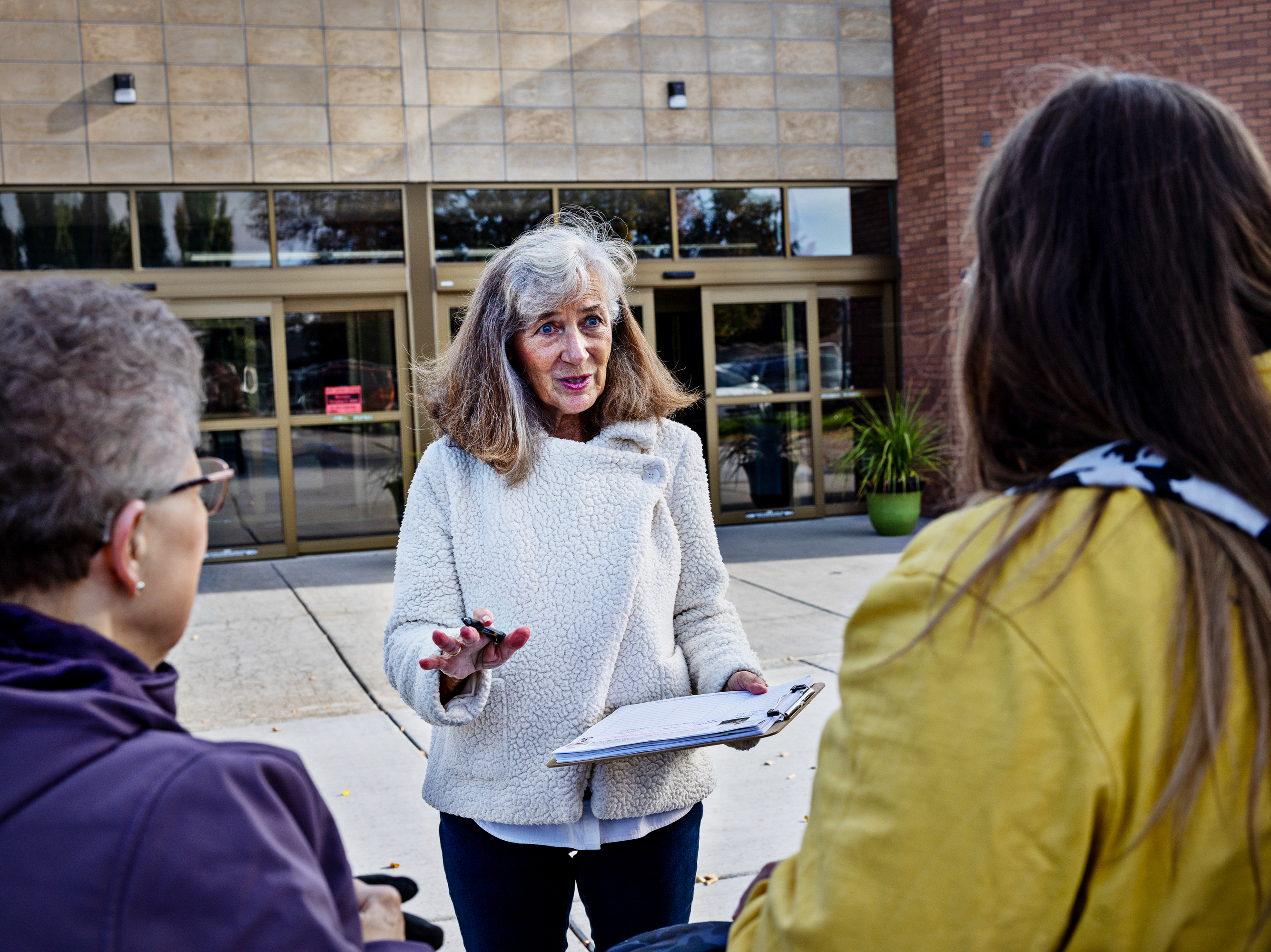 caption: Parents Against Bad Books co-founder Carolyn Harrison (center) talks with people last month outside the public library in Idaho Falls, Idaho, about what she considers obscene books on the shelves.