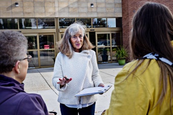 caption: Parents Against Bad Books co-founder Carolyn Harrison (center) talks with people last month outside the public library in Idaho Falls, Idaho, about what she considers obscene books on the shelves.