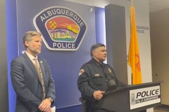 caption: "We're worried and concerned that these are connected and possibly politically motivated or personally motivated," Albuquerque Mayor Tim Keller, left, said earlier this month of a string of shootings. He's seen here alongside Police Chief Harold Medina during a press conference via the Albuquerque Police Department's Facebook livestream.