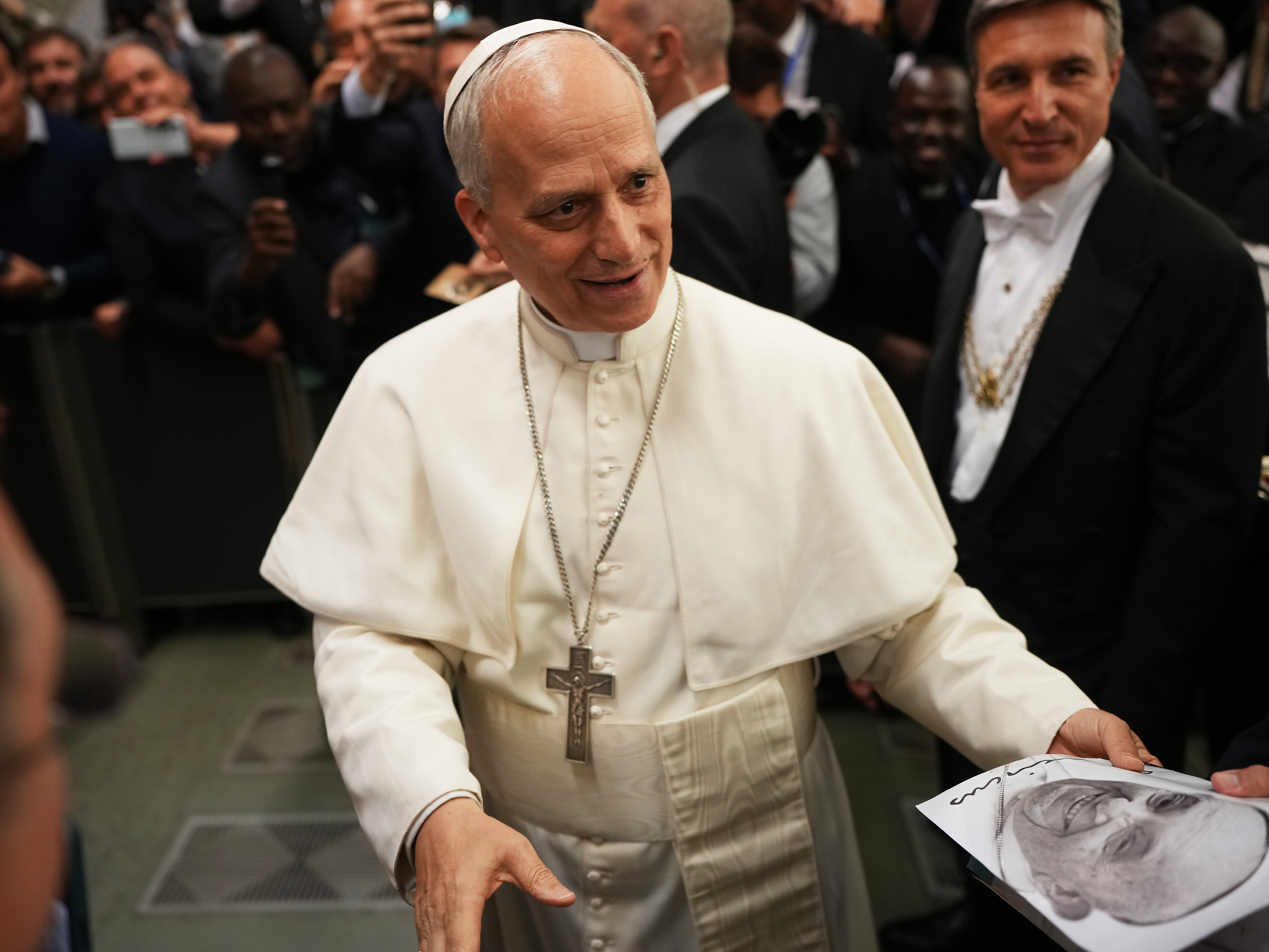 caption: Pope Leo XIV arrives for an audience with thousands of journalists and media workers at Paul VI Audience Hall in Vatican City. The audience with journalists has become a tradition among newly elected popes.