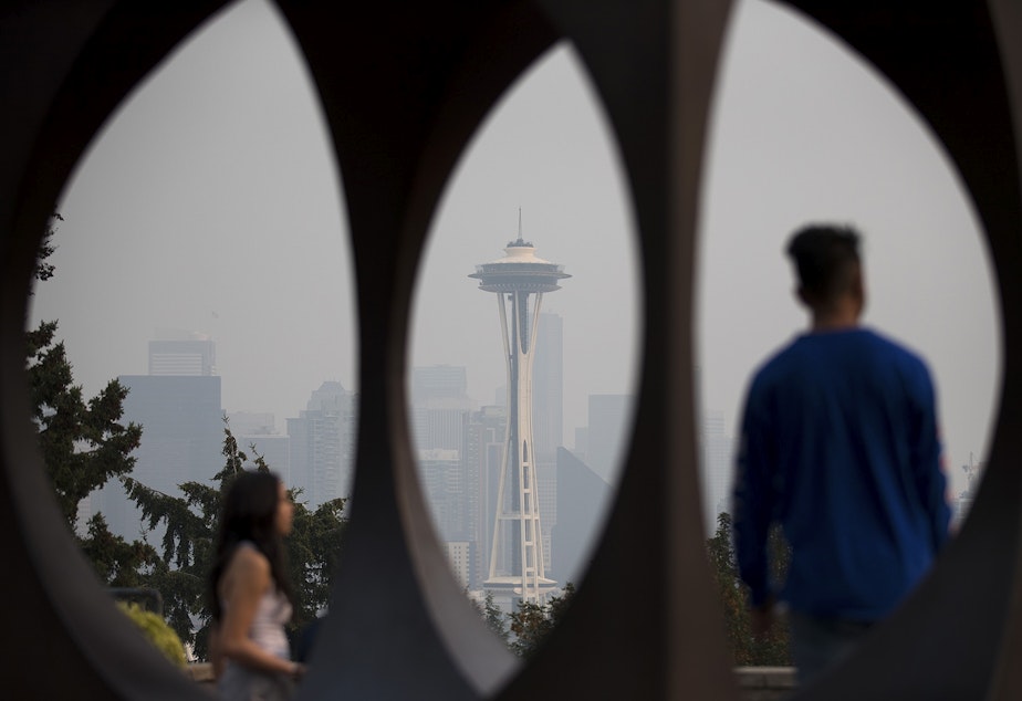 caption: The Space Needle is visible through a sculpture on Monday, August 20, 2018, at Kerry Park in Seattle. Heavy smoke from wildfires has returned to the Seattle area. 