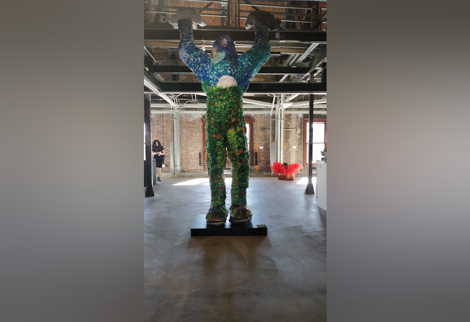 caption: A reimagined version of Bigfoot at ARTS at King Street Station. The official sculpture is titled Lifts the Sky, created by HollyAnna “CougarTracks” DeCoteau Littlebull (Yakama, Nez Perce, Cayuse, Cree).
