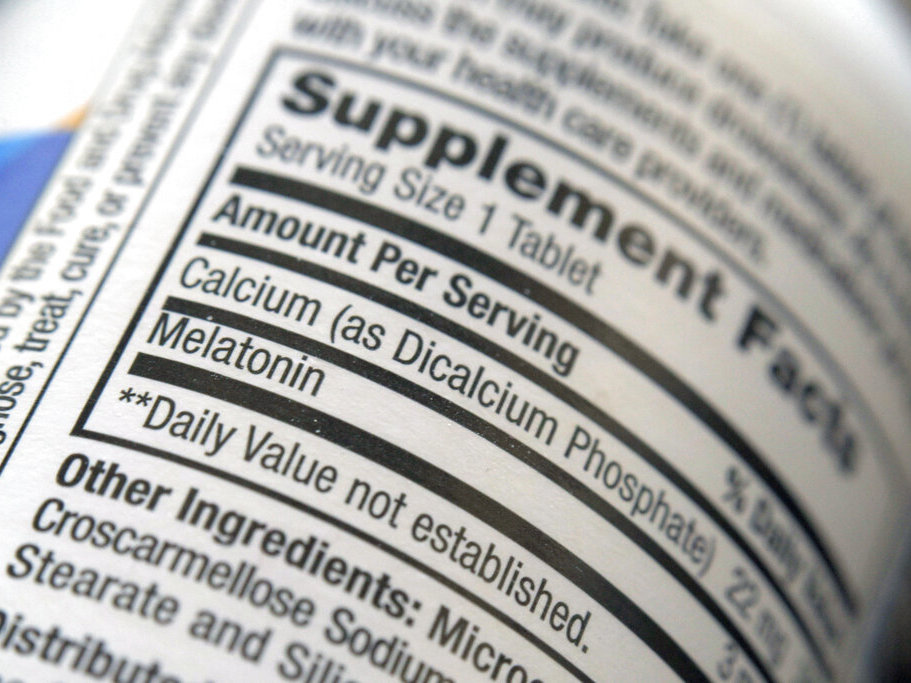 caption: The label for a bottle of melatonin pills. Melatonin is a hormone that helps control the body's sleep cycle.