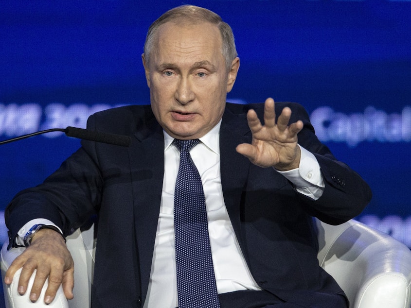 caption: Russian President Vladimir Putin speaks at an economic forum in Moscow on Nov. 20. "Thank God no one is accusing us anymore of interfering in the U.S. elections. Now they're accusing Ukraine," he said.