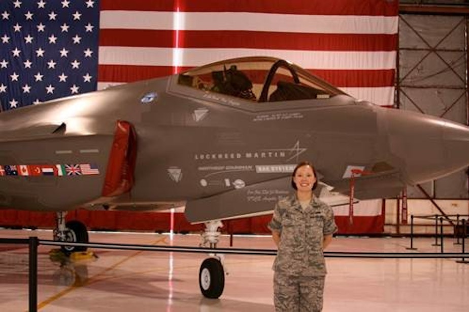 caption: Air Force veteran Katherine Pratt in front of an F-35 Joint Strike Fighter. Pratt's detachment was responsible for the operational tests.