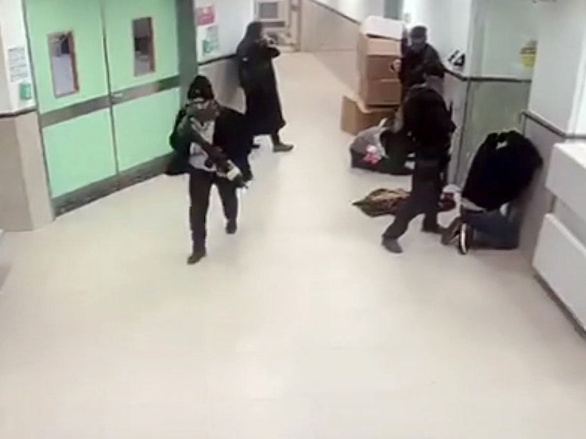 caption: A screen grab from a security camera shows what hospital staff described as Israeli forces in disguise, holding weapons, raiding the Ibn Sina Hospital in Jenin, West Bank, on Tuesday,