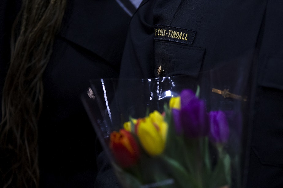 caption: King County Sheriff Patti Cole-Tindall, center, holds a bouquet after graduating from the 720-hour Basic Law Enforcement Academy on Tuesday, March 28, 2023, at the Washington State Criminal Justice Commission in Burien.
