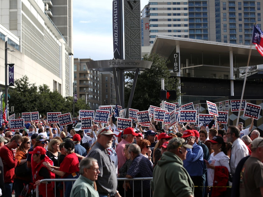 caption: Attendees hold "We Vape, We Vote" signs ahead of a Trump rally last month in Dallas. The politics surrounding vaping and industry pushback against regulation appear to have derailed the Trump administration's plan to ban the sales of many vaping products.