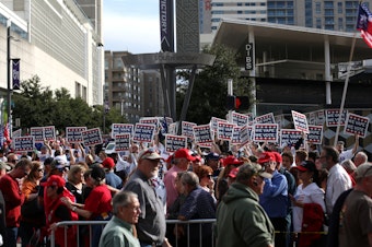 caption: Attendees hold "We Vape, We Vote" signs ahead of a Trump rally last month in Dallas. The politics surrounding vaping and industry pushback against regulation appear to have derailed the Trump administration's plan to ban the sales of many vaping products.