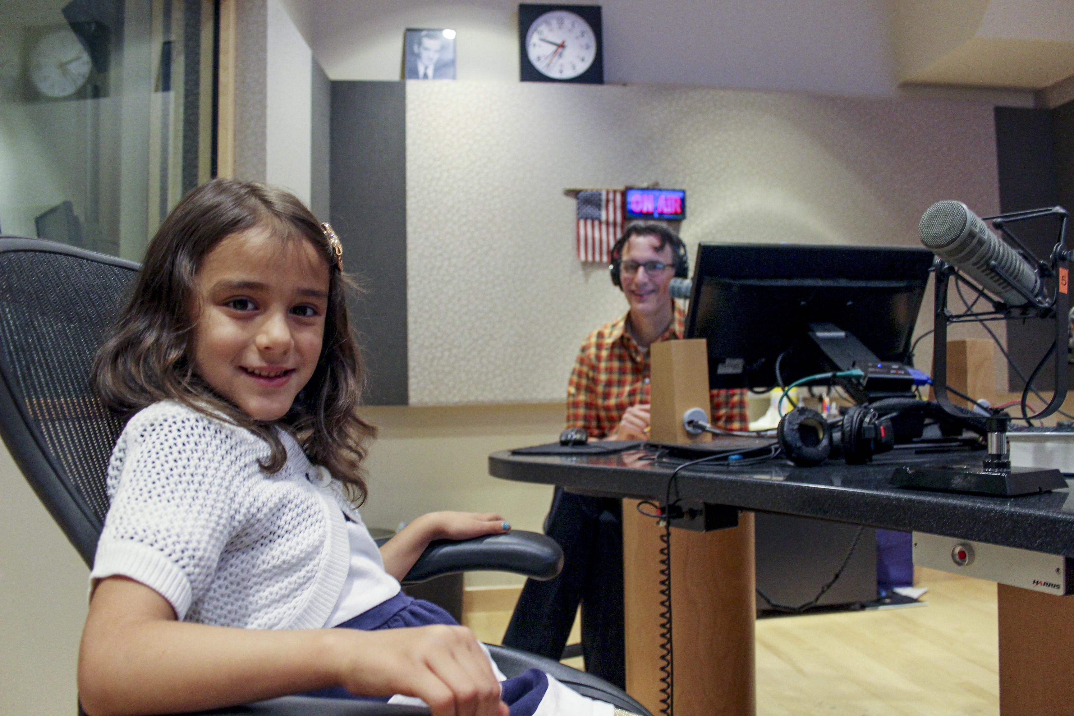 caption: Ellie Suastez chats with Bill Radke at the KUOW studios.