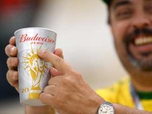 caption: A Brazil fan points to "zero" on the Budweiser cup prior to the FIFA World Cup Qatar 2022 Group G match between Brazil and Serbia at Lusail Stadium in Lusail City, Qatar.