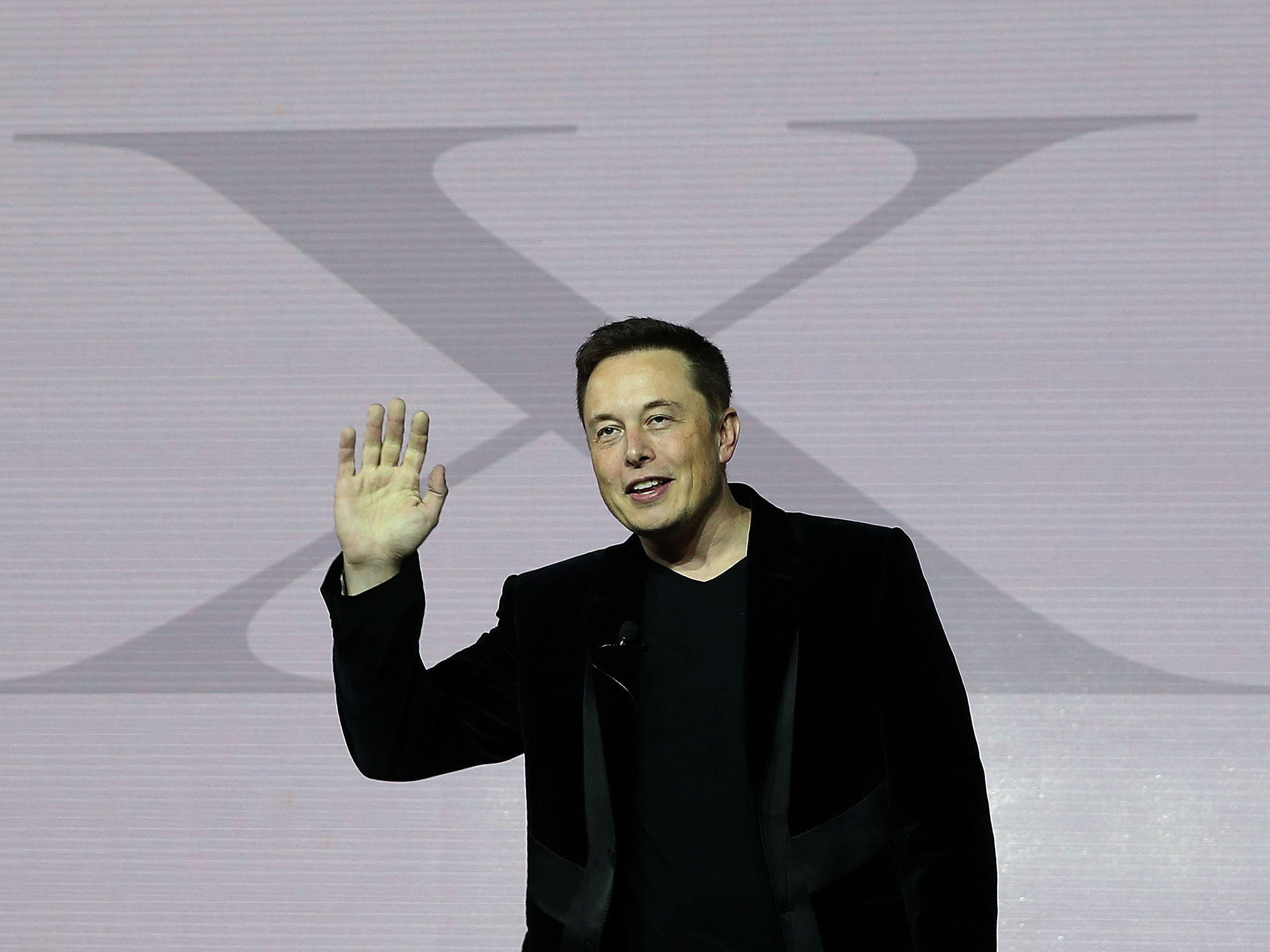 caption: Tesla CEO Elon Musk speaks during an event to launch the new Tesla Model X Crossover SUV on Sept. 2015 in Fremont, California. The billionaire has a long-time affinity for the letter "X."