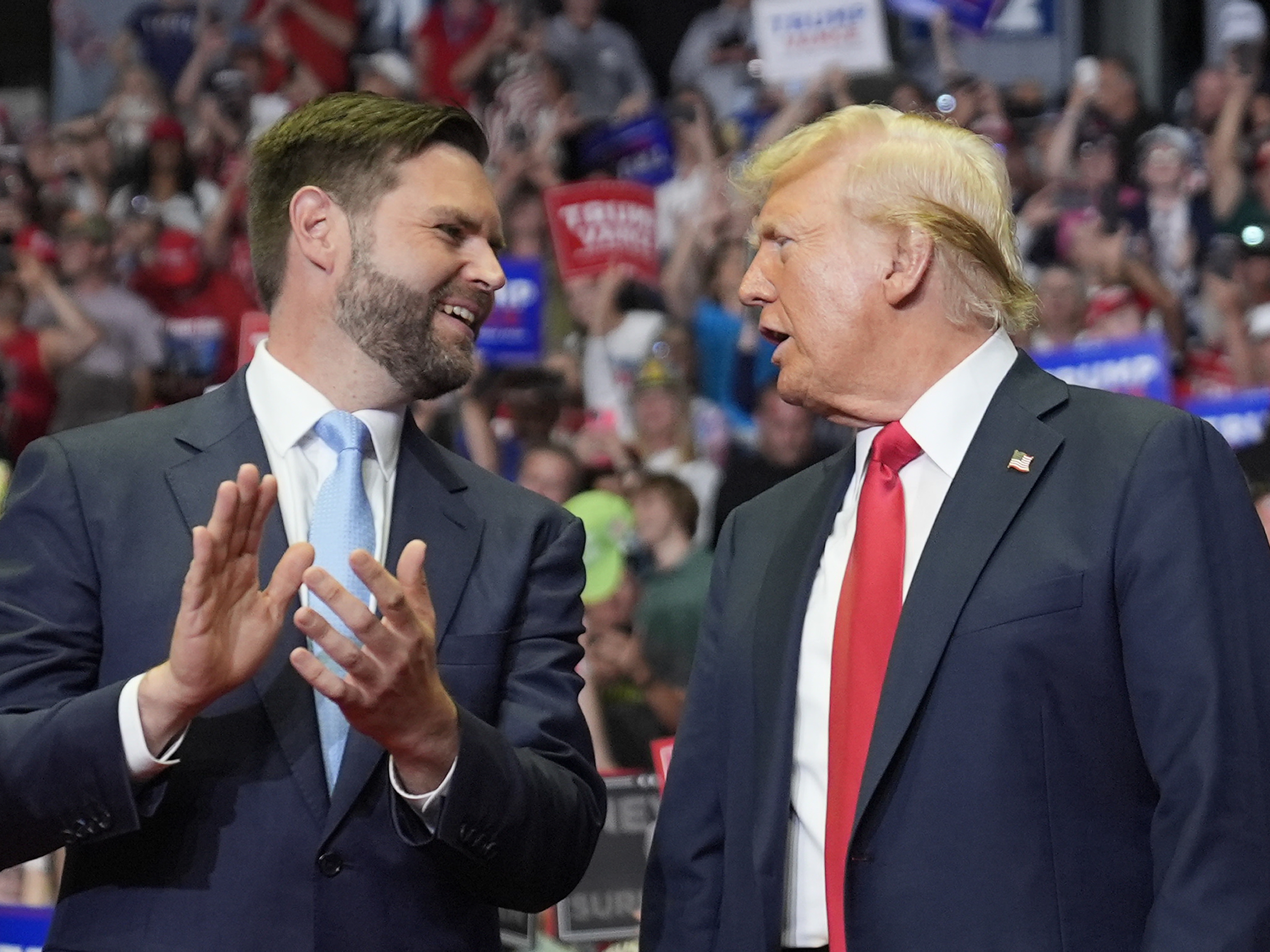 caption: Former President Donald Trump and Republican vice presidential candidate Sen. JD Vance, R-Ohio, arrive a campaign rally on Saturday in Grand Rapids, Mich. 