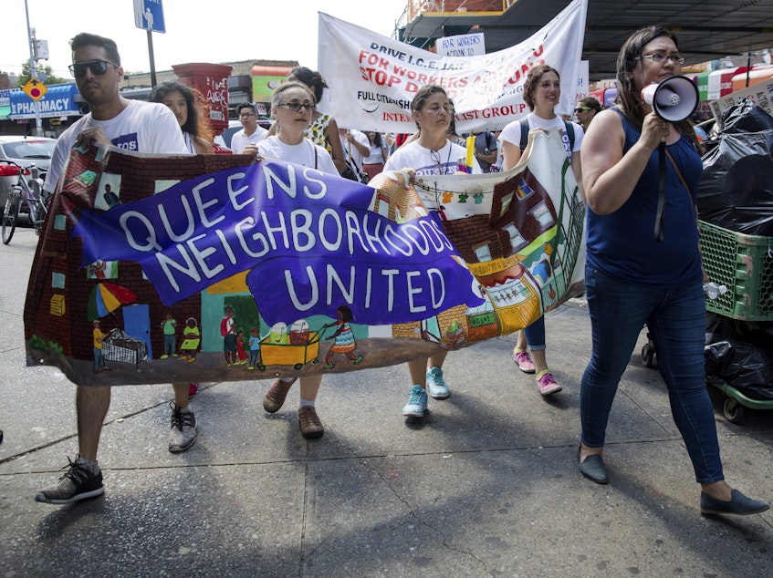 caption: In New York City, hundreds of people march in Queens on Sunday in opposition to the Trump administration's plans to continue with raids to catch immigrants in the country illegally.