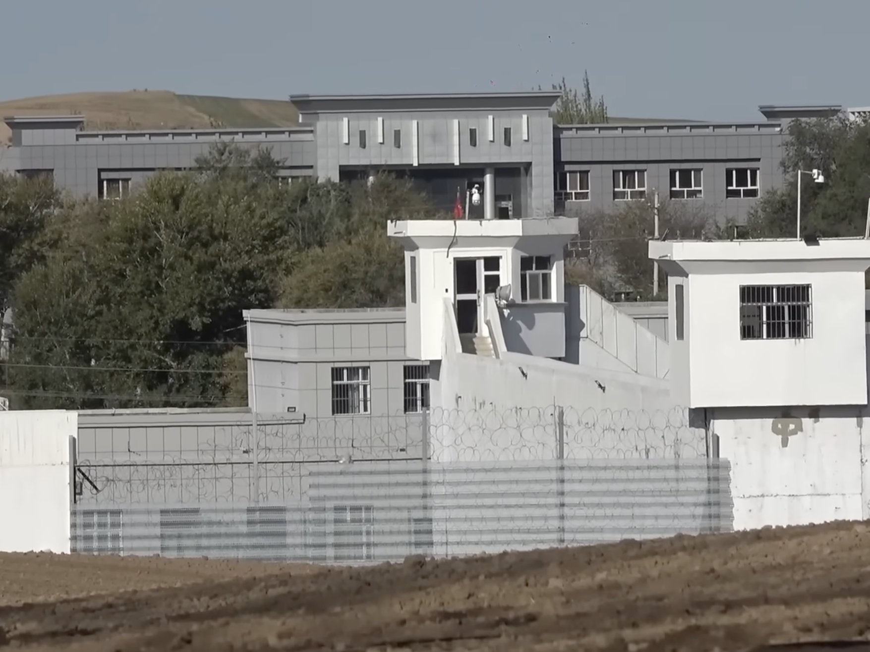 caption: A screenshot from a 2021 video taken by Guan Heng shows what he said was a detention center in the Xinjiang region of China.