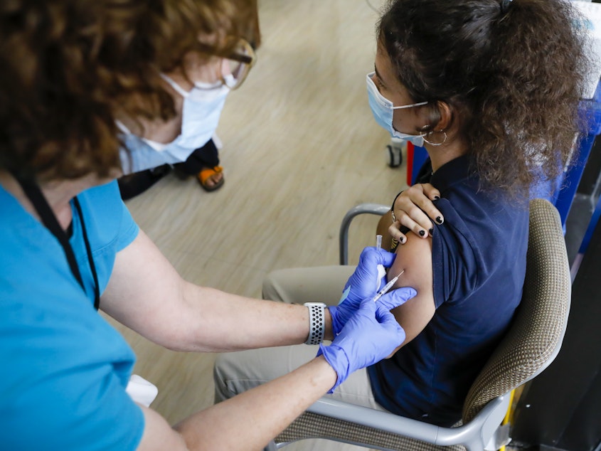 caption: A teen gets a dose of Pfizer's COVID-19 vaccine last month at Holtz Children's Hospital in Miami. Nearly 7 million U.S. teens and preteens (ages 12 through 17) have received at least one dose of a COVID-19 vaccine so far, the CDC says.