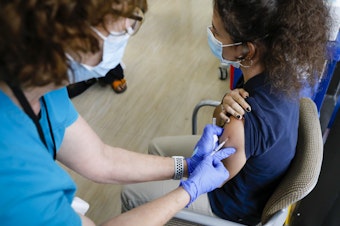 caption: A teen gets a dose of Pfizer's COVID-19 vaccine last month at Holtz Children's Hospital in Miami. Nearly 7 million U.S. teens and preteens (ages 12 through 17) have received at least one dose of a COVID-19 vaccine so far, the CDC says.