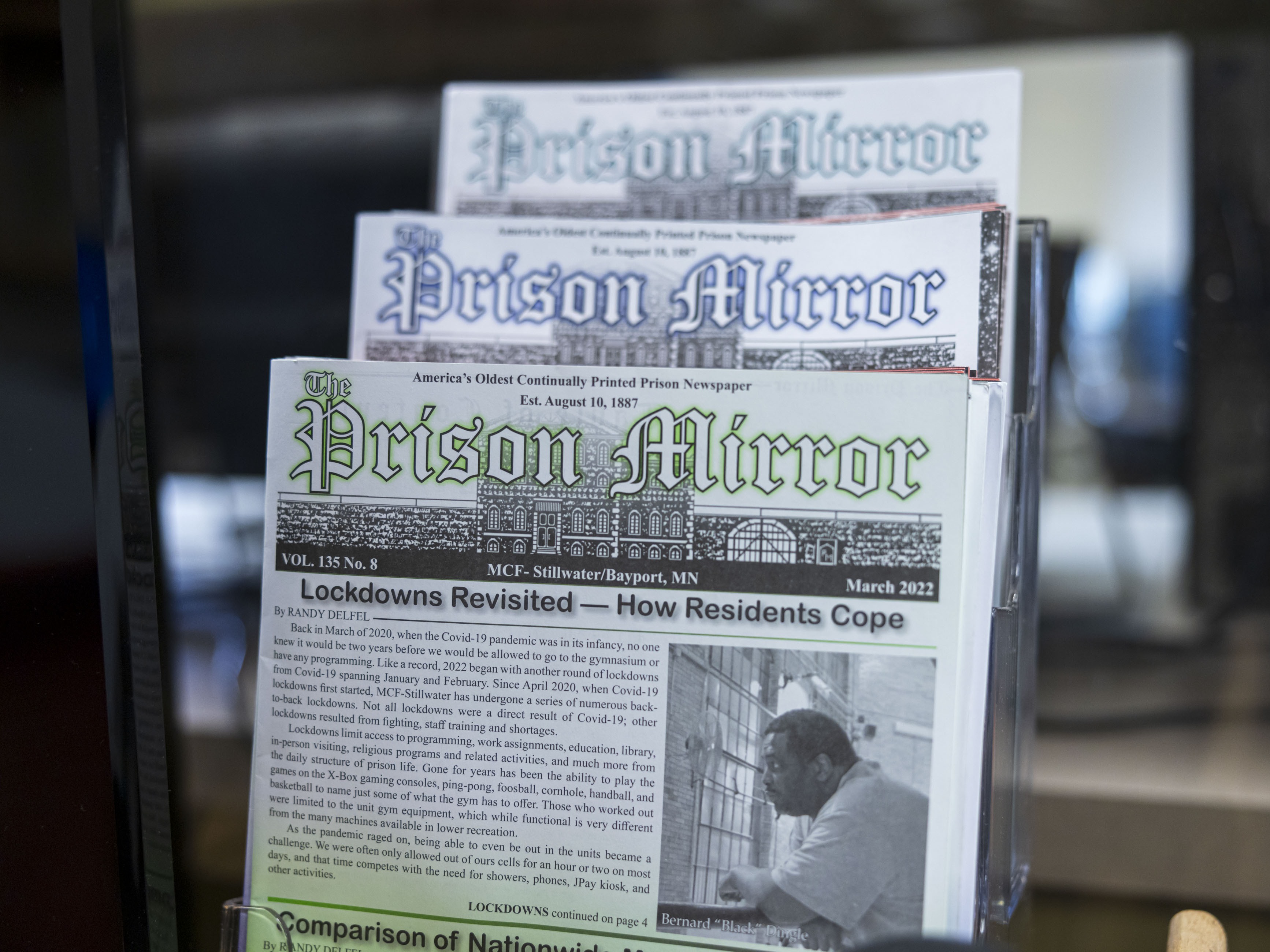 caption: Previous issues of the <em>Prison Mirror, </em>which has been publishing since 1887, sit on display in the Minnesota Correctional Facility - Stillwater.