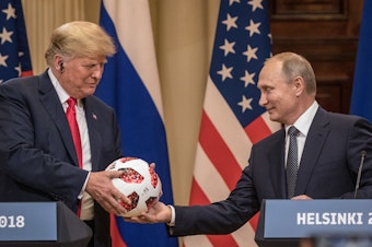 caption: Russian President Vladimir Putin hands President Trump a World Cup soccer ball during a joint news conference after their summit on July 16, 2018, in Helsinki.