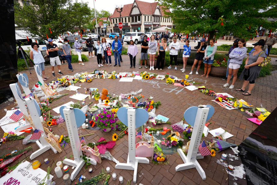 caption: Area residents visit a memorial to the seven people who lost their lives in the Highland Park, Ill., Fourth of July mass shooting, Wednesday, July 6, 2022, in Highland Park. 