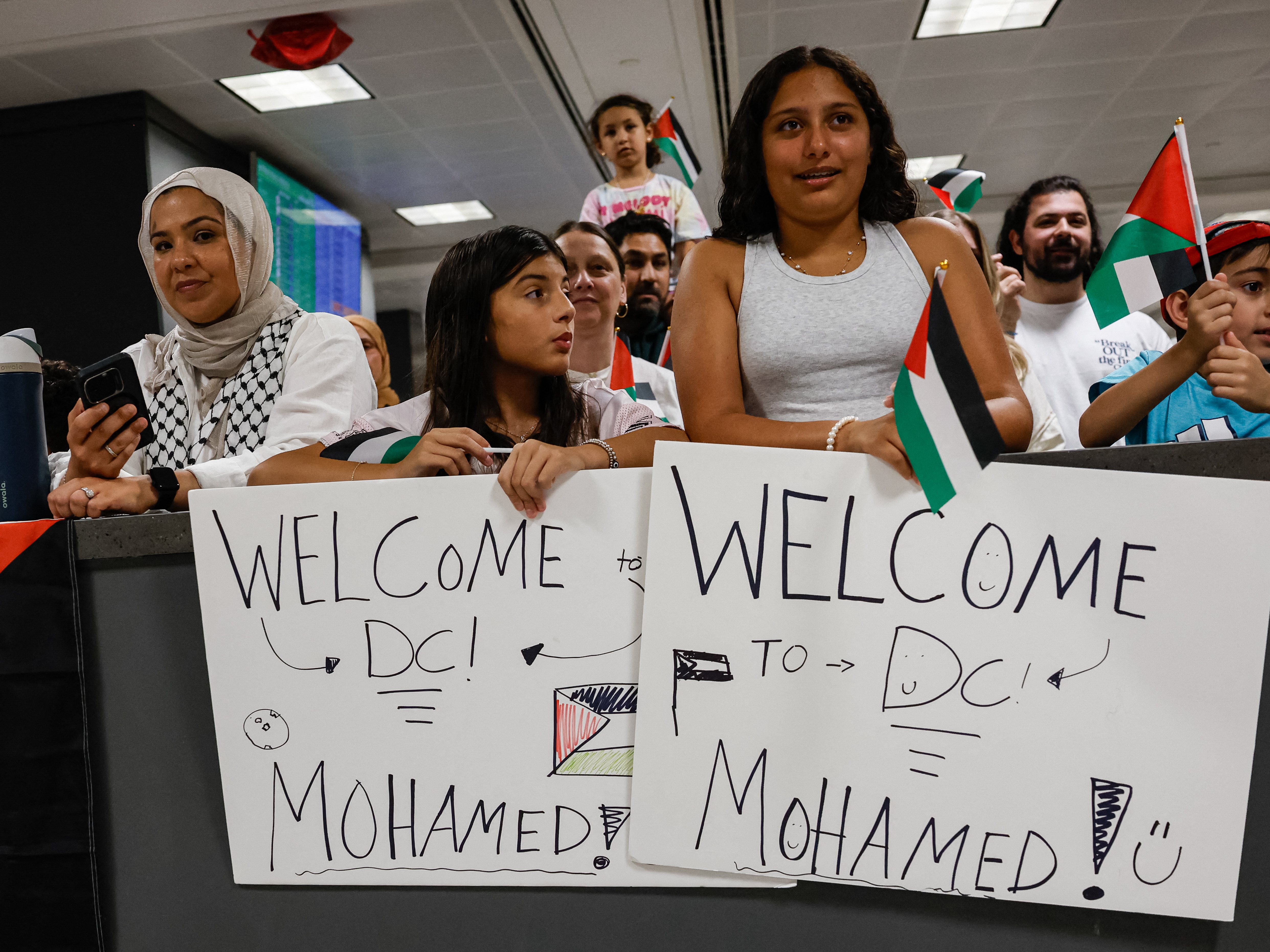 caption: A group of people gather to greet two severely wounded Palestinian teenagers from Gaza arriving at Dulles International Airport near Washington for urgent medical treatment on Aug. 9, 2025.