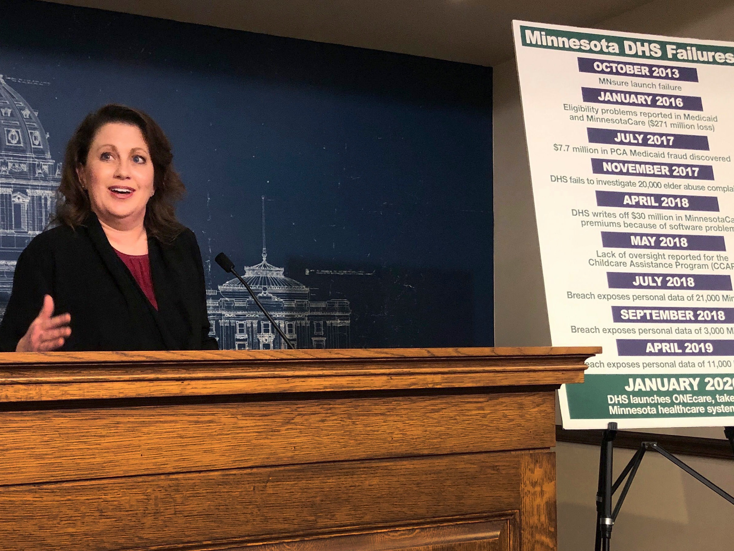 caption: State Sen. Michelle Benson reacts at a news conference on April 10, 2019, at the Minnesota State Capitol in St. Paul to a report by the state's legislative auditor on combatting fraud in Minnesota's Child Care Assistance Program.