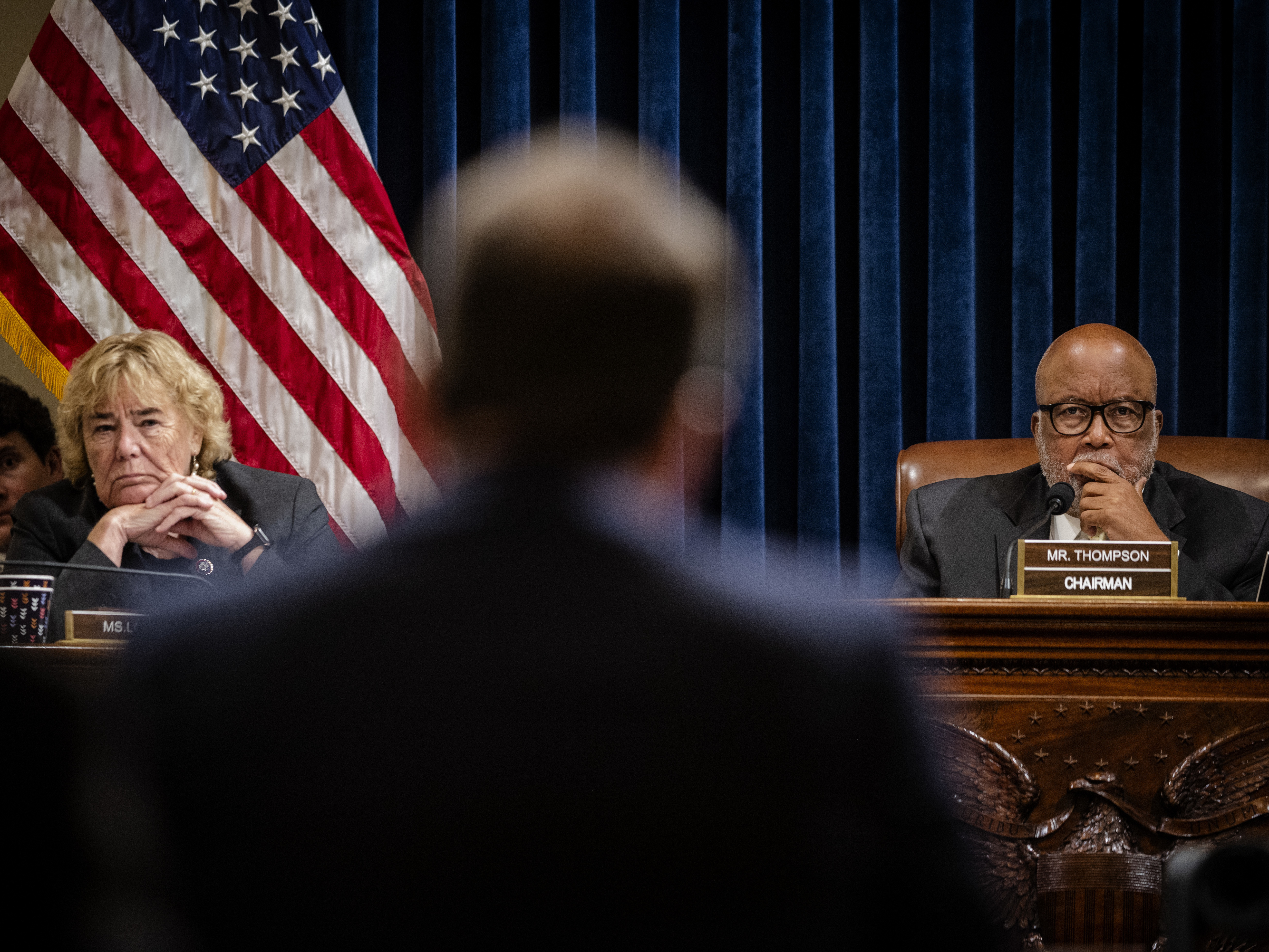 caption: House Select Committee Chair Rep. Bennie Thompson, D-Miss., right, and Rep. Zoe Lofgren, D-Calif., listen during the panel's first hearing last month. The committee has asked 35 social media and communication companies to preserve records associated with the Jan. 6 insurrection.