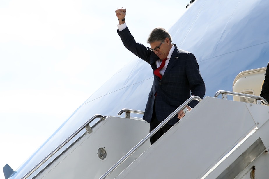 caption: Energy Secretary Rick Perry gestures as he arrives on Air Force One with President Donald Trump at Naval Air Station Joint Reserve Base in Fort Worth, Texas, Thursday, Oct. 17, 2019. He submitted his intention to resign on the same day.