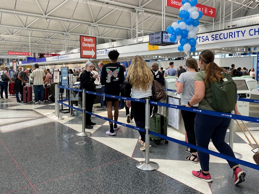 caption: Travelers line up to get into the security checkpoint at Chicago's O'Hare airport last summer.
