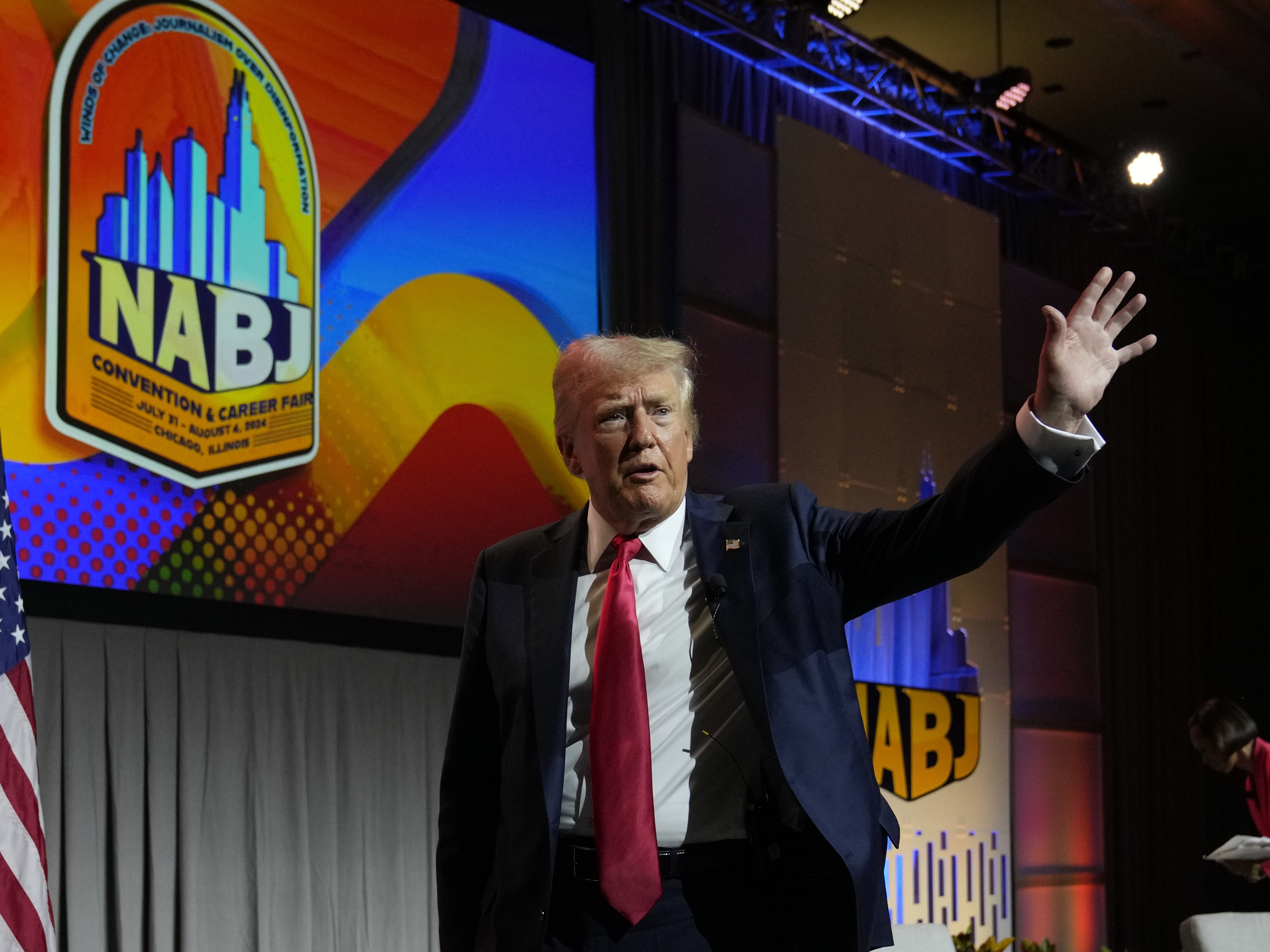 caption: Former President Donald Trump walks off stage after speaking at the National Association of Black Journalists convention in Chicago on Wednesday.