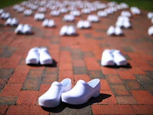 caption: National Nurses United set out empty pairs of shoes for nurses who have died from COVID-19 while demonstrating across from the White House on May 7. The union is asking employers and the government to provide safe workplaces, including adequate staffing. Hospitals have been laying off and furloughing nurses due to lost revenue.