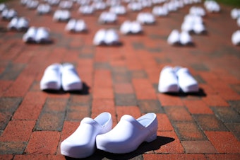 caption: National Nurses United set out empty pairs of shoes for nurses who have died from COVID-19 while demonstrating across from the White House on May 7. The union is asking employers and the government to provide safe workplaces, including adequate staffing. Hospitals have been laying off and furloughing nurses due to lost revenue.