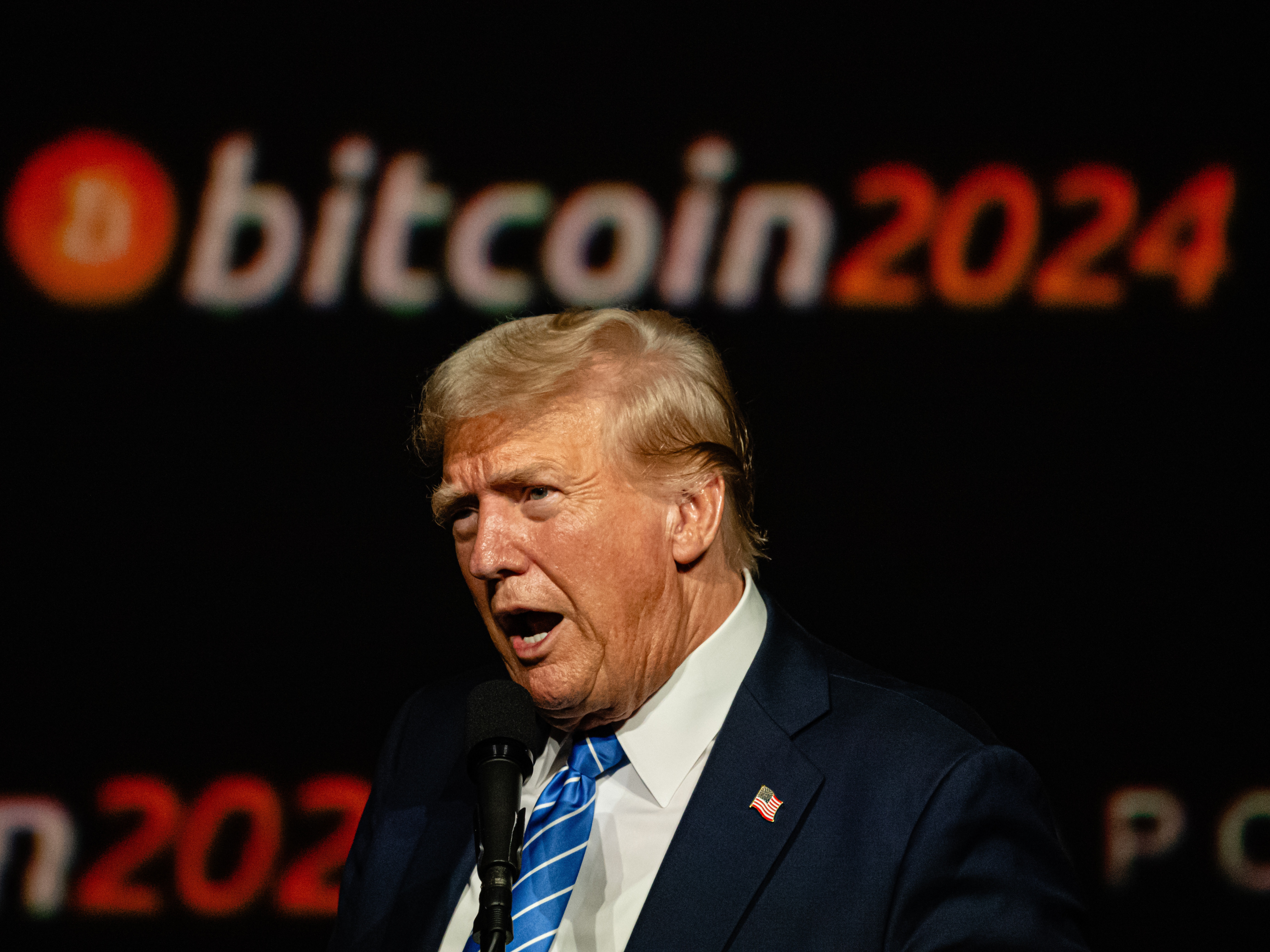 caption: Trump gives a keynote speech at the Bitcoin 2024 conference in Nashville on July 27, 2024. Bitcoin has surged since Trump's election amid hopes he will usher in an administration friendly to its interests.