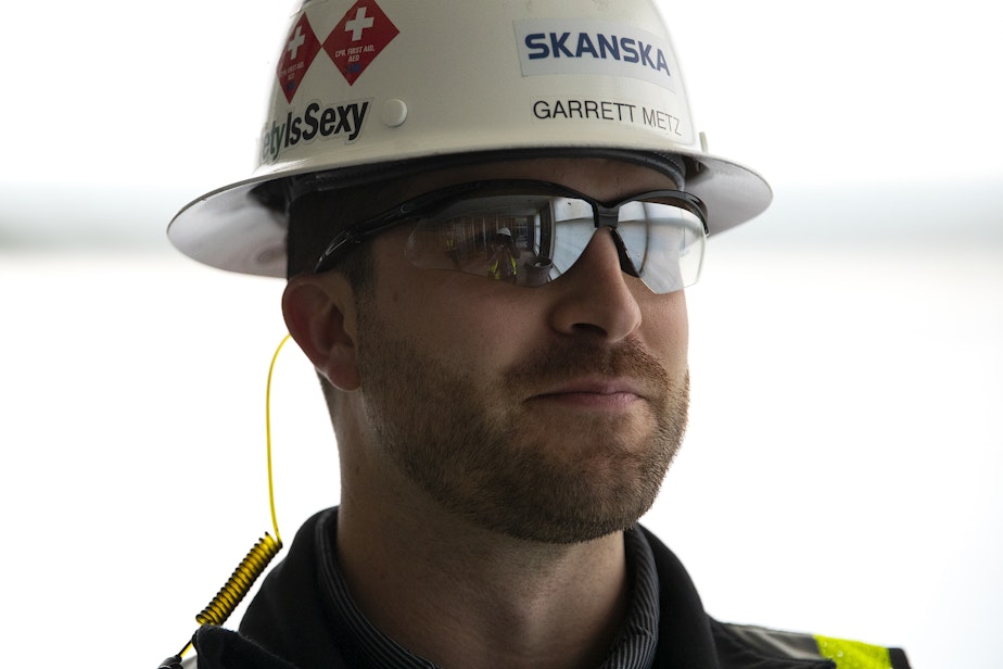 caption: Garrett Metz, senior project engineer, is portrayed at a construction site of a new apartment building on Monday, June 17, 2024, along Third Avenue in Seattle.