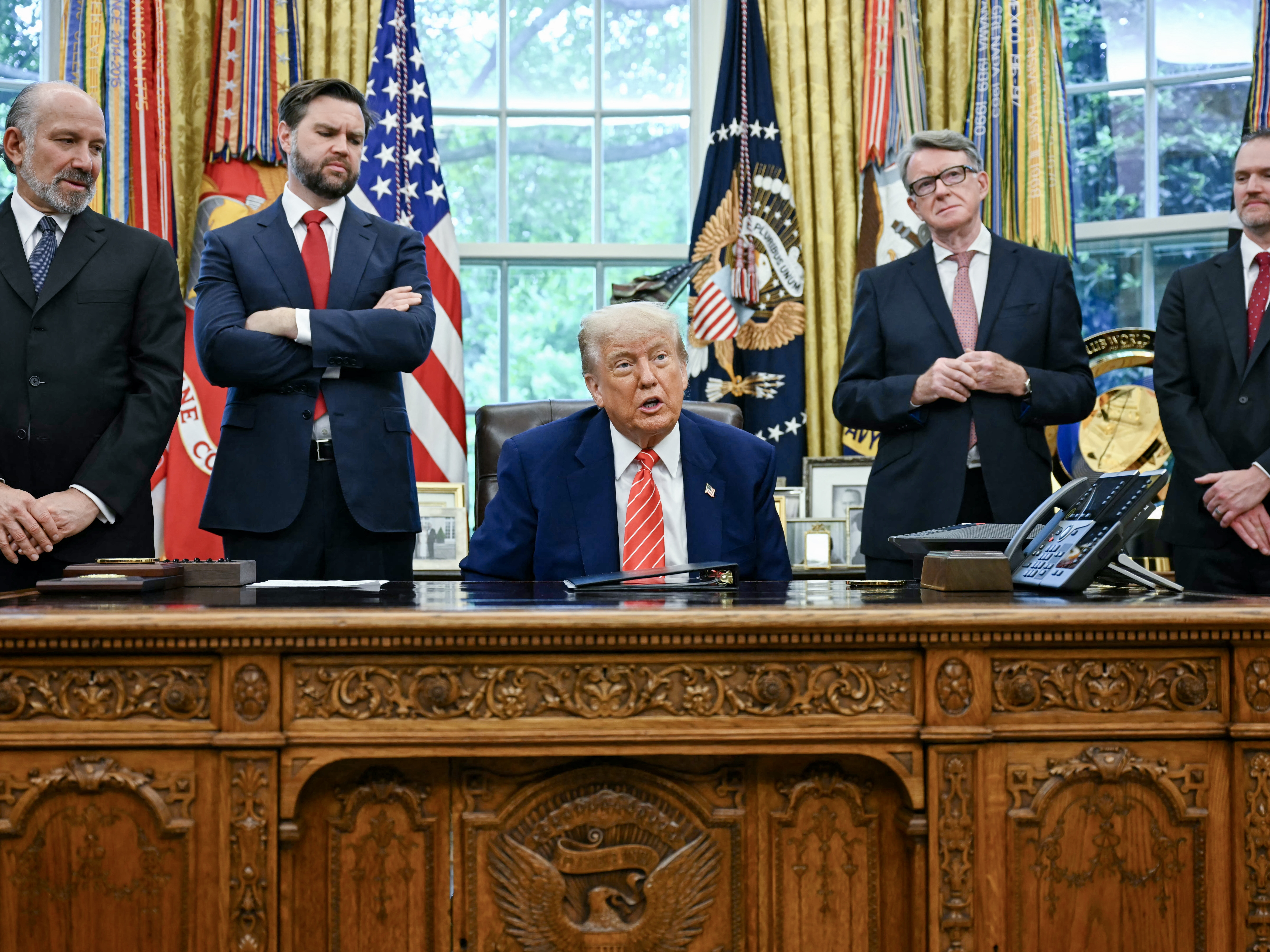 caption: President Trump announces a trade agreement with the United Kingdom on May 8, 2025 as Commerce Secretary Howard Lutnick, Vice President Vance, British Ambassador Peter Mandelson and U.S. Trade Representative Jamieson Greer look on.