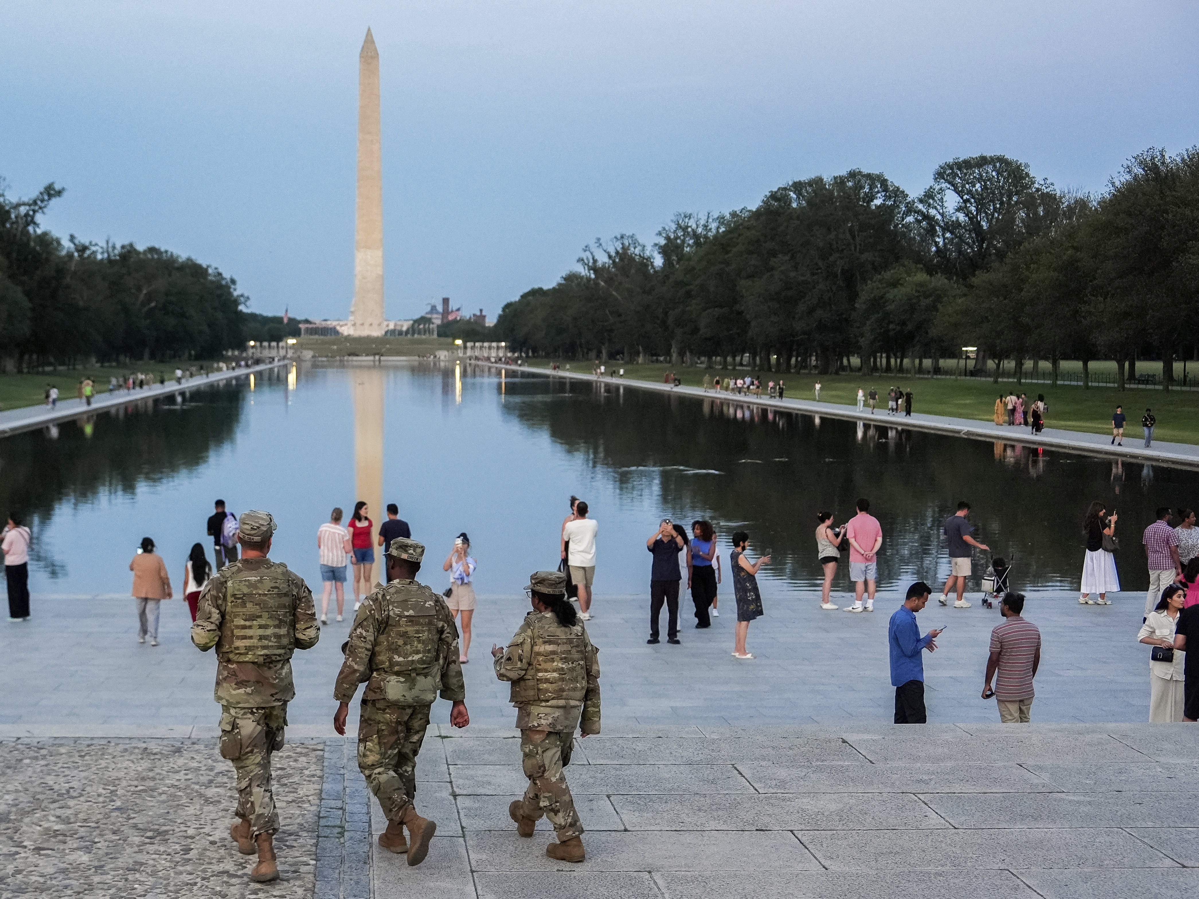 caption: Members of the District of Columbia National Guard patrol along the National Mall, Saturday, Aug. 16, 2025, in Washington.