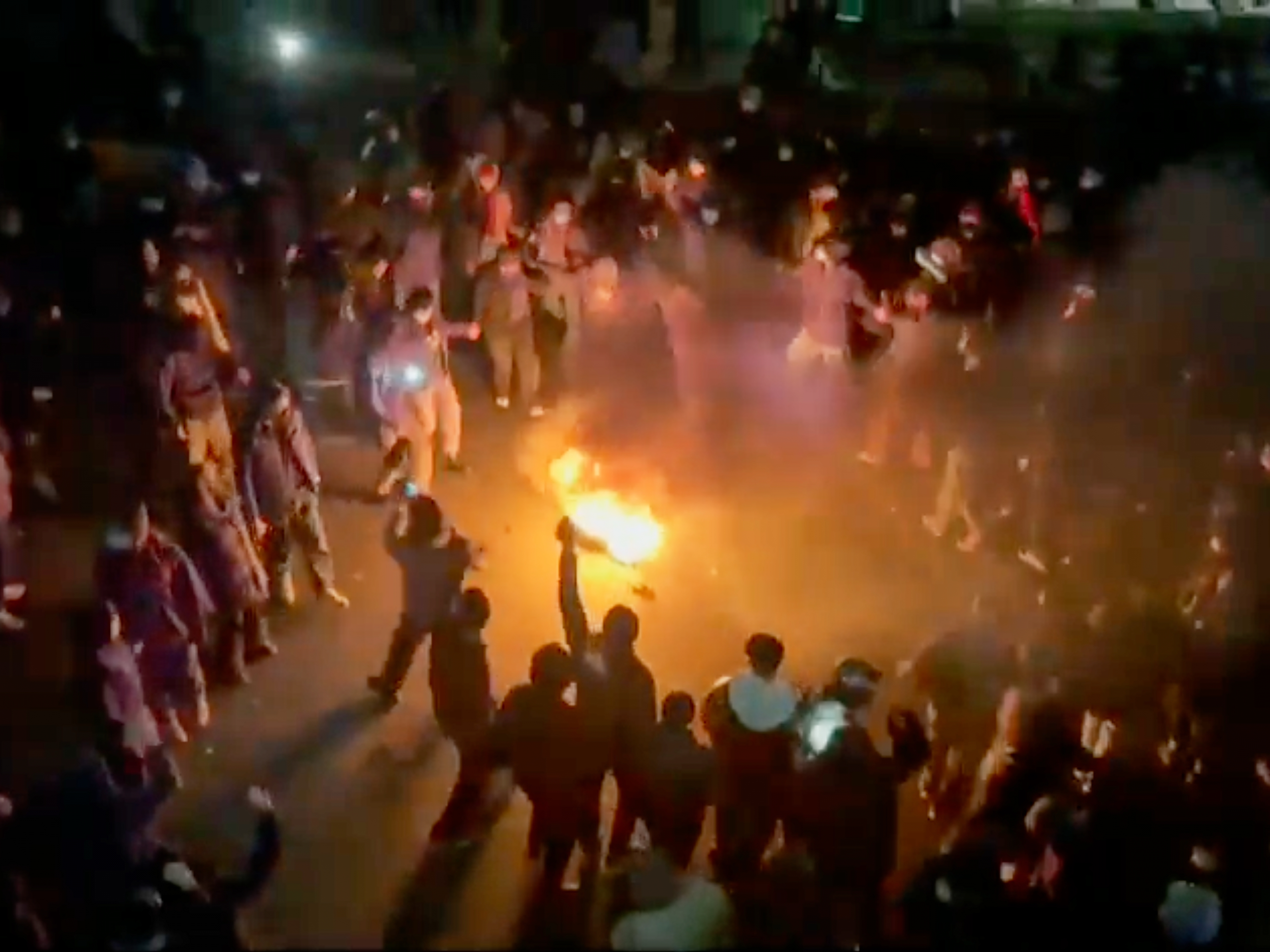 caption: This frame grab from footage circulating on social media shows protesters dancing and cheering around a bonfire on Friday in Tehran, Iran. Protesters have taken to the streets despite an intensifying crackdown.
